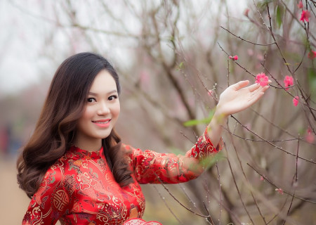 woman-wearing-red-long-sleeved-dress-holding-pink-petaled-807842